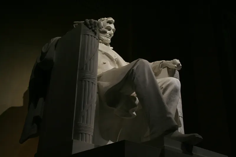 The seated statue of Abraham Lincoln at the Lincoln Memorial at night