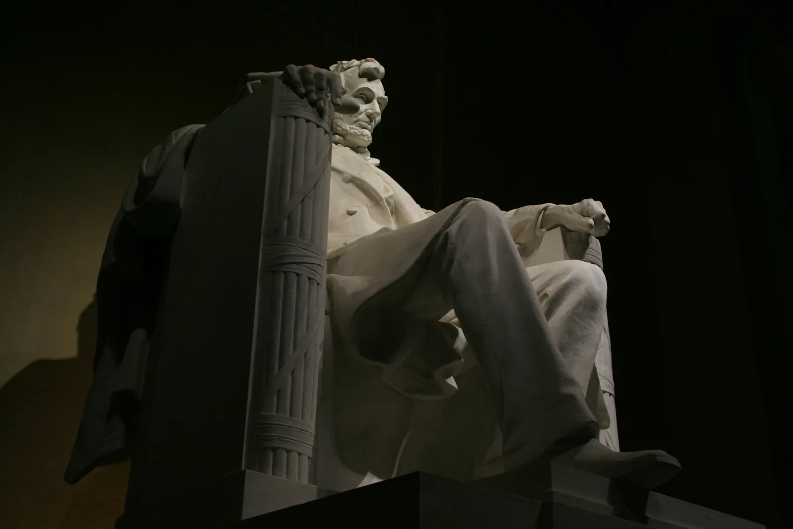 The seated statue of Abraham Lincoln at the Lincoln Memorial at night